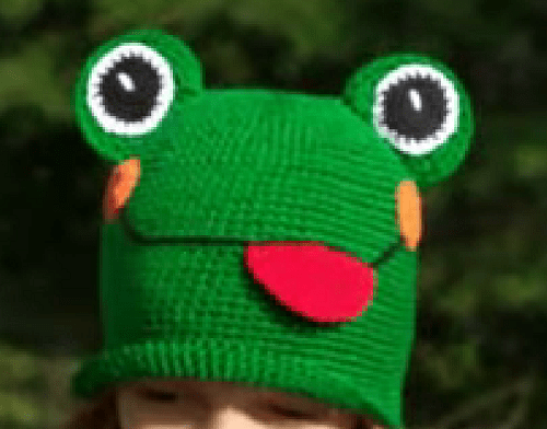 Finished green frog hat with eyes, blush spots, and a red tongue