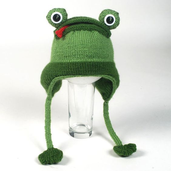 Reference photo of a frog hat with a brim and ties on a display form
