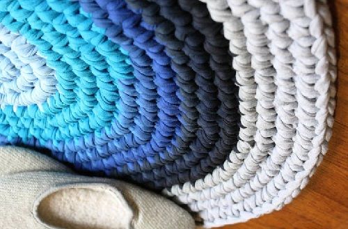 Close-up of a round crocheted rug in blue and gray tones