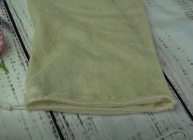 Finished drawstring casing with cord inserted into a mesh bag