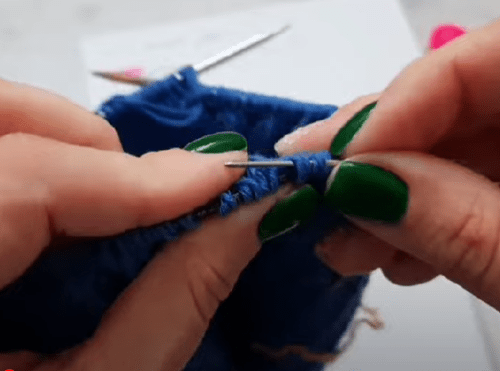 A contrast thread run through stitches for the future snood