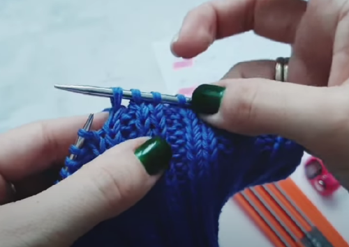 A crown decrease through the front loop while knitting a balaclava