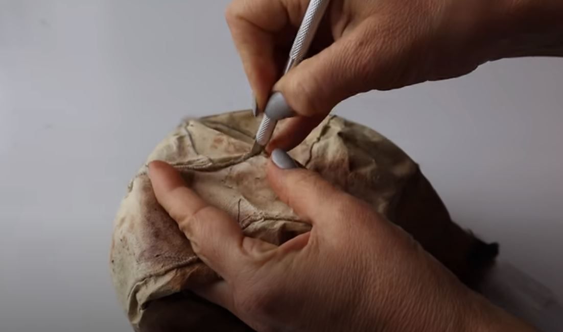Hand-cutting a fur piece for a future collar