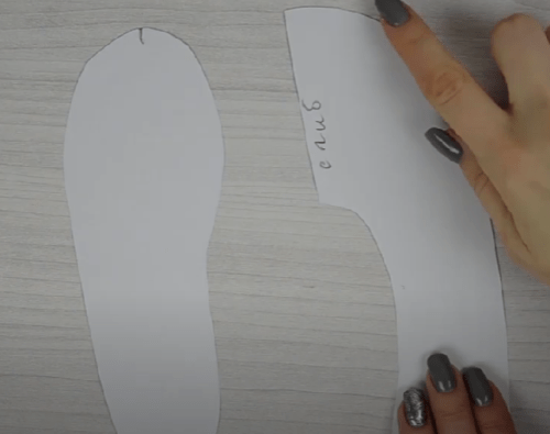 Paper pattern pieces for a child’s slipper sole and upper