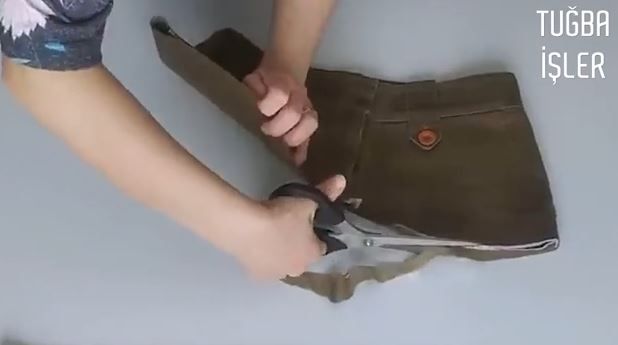 Trimming the lower edge of the trouser-top yoke with scissors
