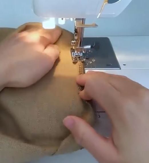Turning and stitching the lower hem of the skirt