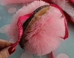 Pink tulle pom-pom tied with a polka-dot ribbon