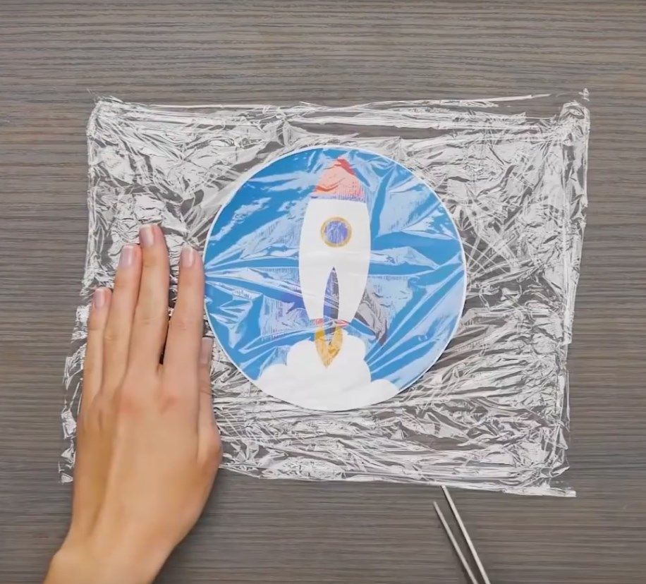 Trimming the excess plastic film