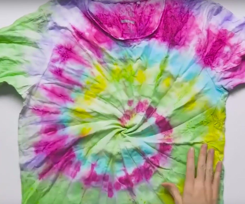 Spiral tie-dye T-shirt laid flat after dyeing