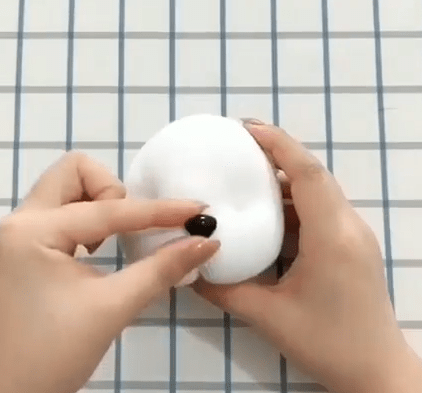 Shaping the toy's face with a black nose