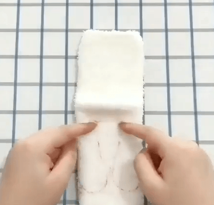 Paw outlines marked on a white sock for a toy