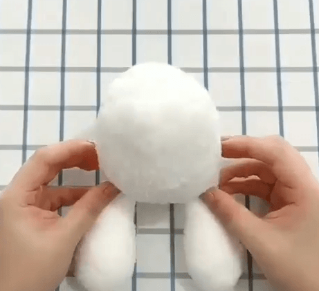 Round sock-toy head with two paws