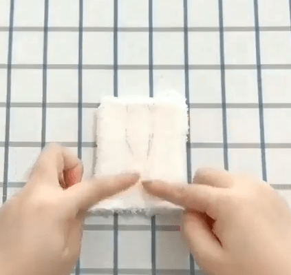 Rectangular white sock piece marked with long ear outlines