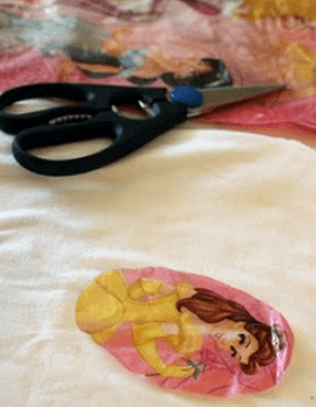 Plastic cutout placed on fabric