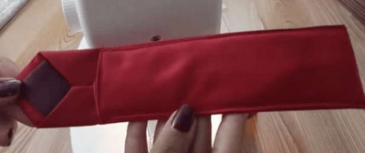 Folded tie forming an open envelope pouch
