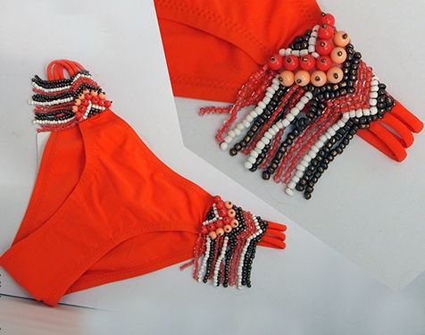Orange swimsuit with sewn-on beaded embellishment