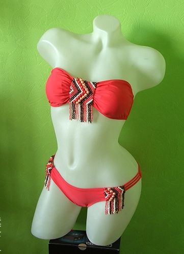 Orange swimsuit after the makeover on a mannequin