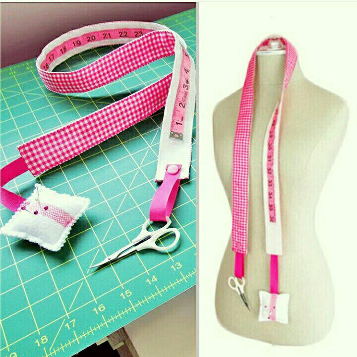 Mini sewing organizer: fabric strip with glued measuring tape, small pincushion and pocket holding scissors