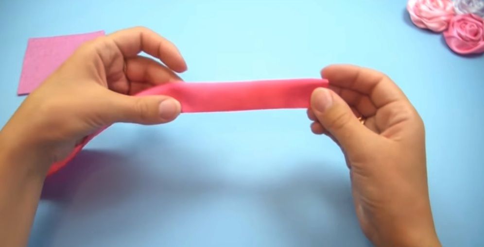 Pink satin ribbon folded in four