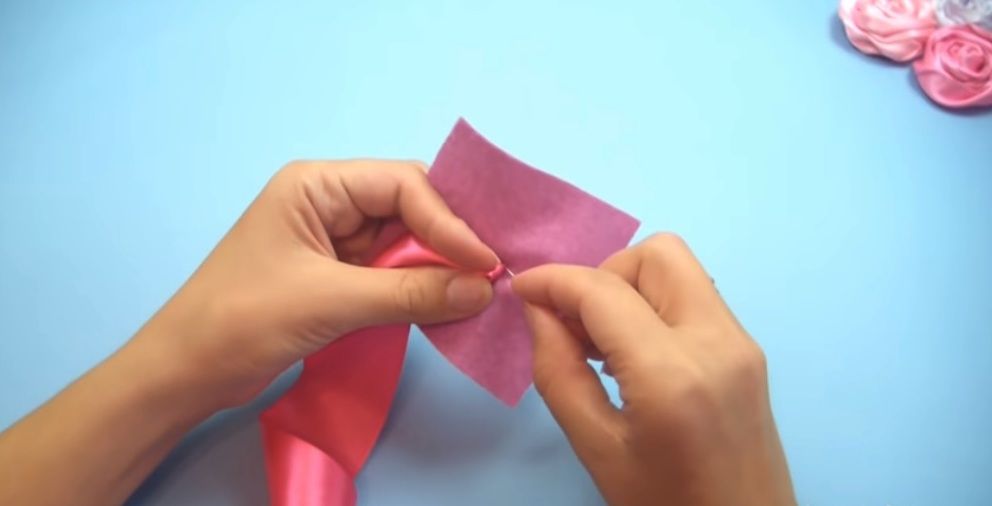 Sewing the ribbon rose center to a felt square