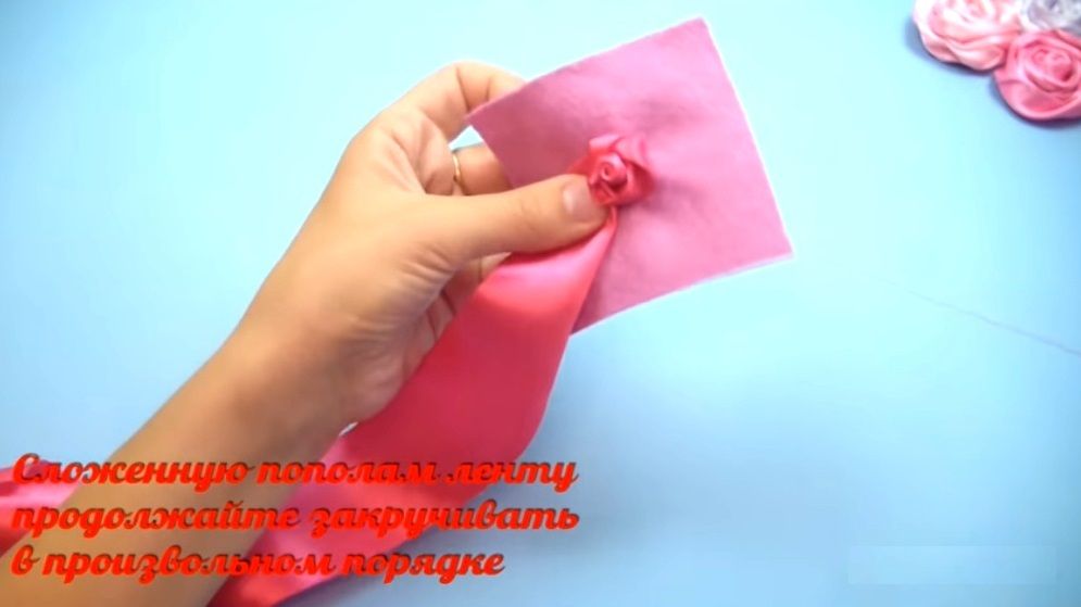 Continuing to wrap the satin ribbon around the rose center