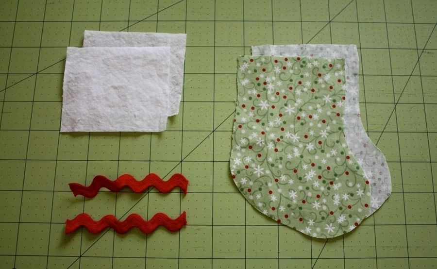 Fabric boot pieces, white trim, and two lengths of red rickrack
