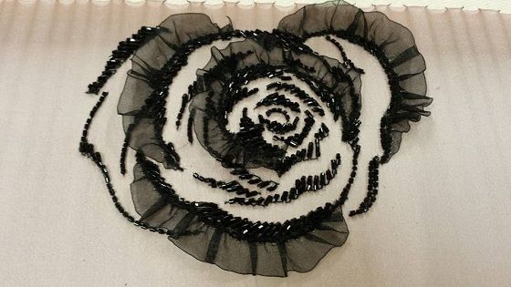 A delicate fabric rose on a T-shirt