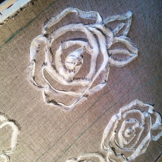 A finished fabric rose decoration on a garment