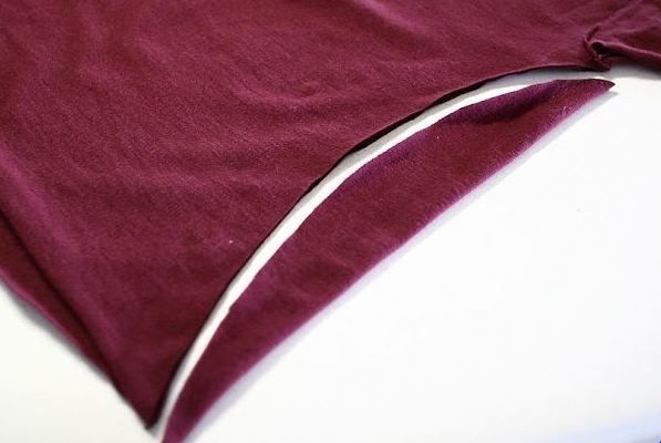 Cutting the excess fabric from the T-shirt