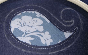 Outline of the paisley-shaped appliqué in an embroidery hoop