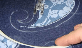 Sewing a decorative stitch along the appliqué