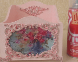 Box with pink decor and a rose-bouquet image next to the paint