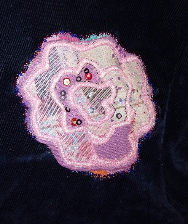 The finished turtleneck with a beaded floral appliqué