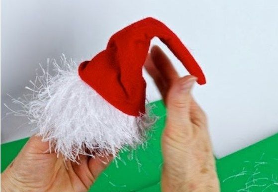 Red felt elf hat with the white beard glued on