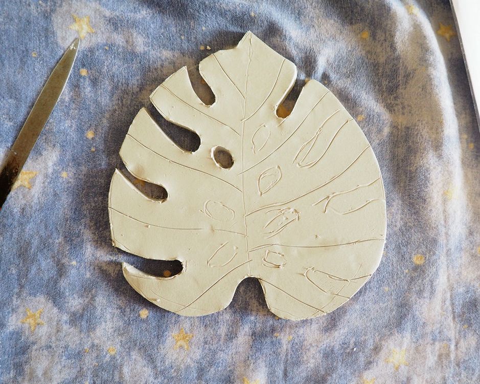 Rough monstera leaf cut from clay along the outer outline