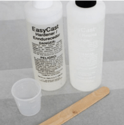 Resin, hardener, measuring cup, and mixing stick