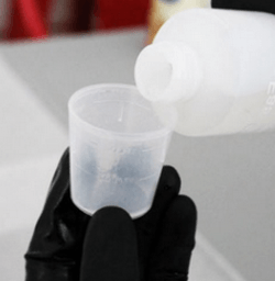 Pouring the first resin component into a measuring cup