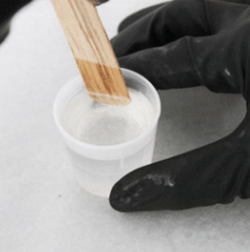 Stirring the resin with a wooden stick