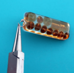 Attaching a jump ring to a rectangular resin pendant