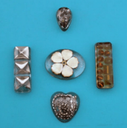 Small resin blanks with various inclusions on a light blue background