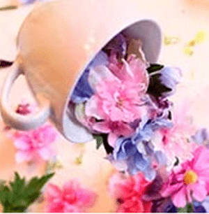 Floating cup with a cascade of pink and blue flowers