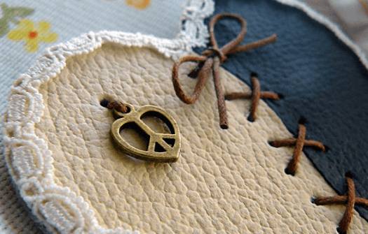 Finished lace-trimmed leather heart magnet