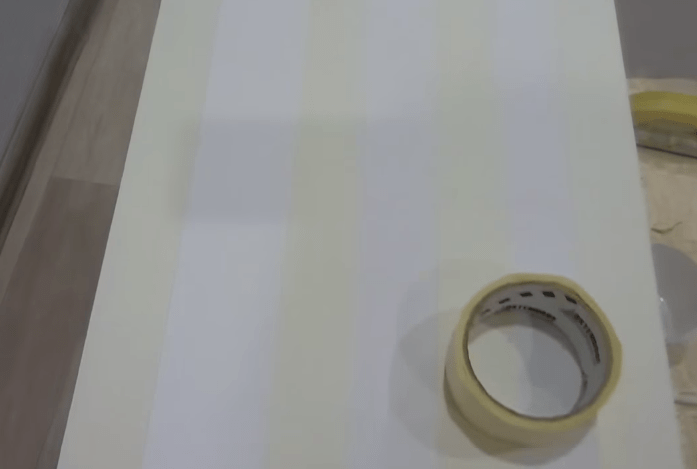 Applying masking tape for stripes