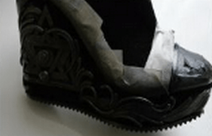 Applying spray paint to the clay ornament