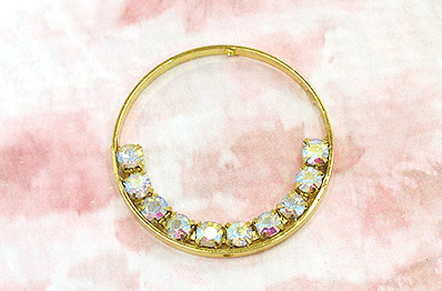 Gold-tone hoop earring with a glued strip of rhinestones