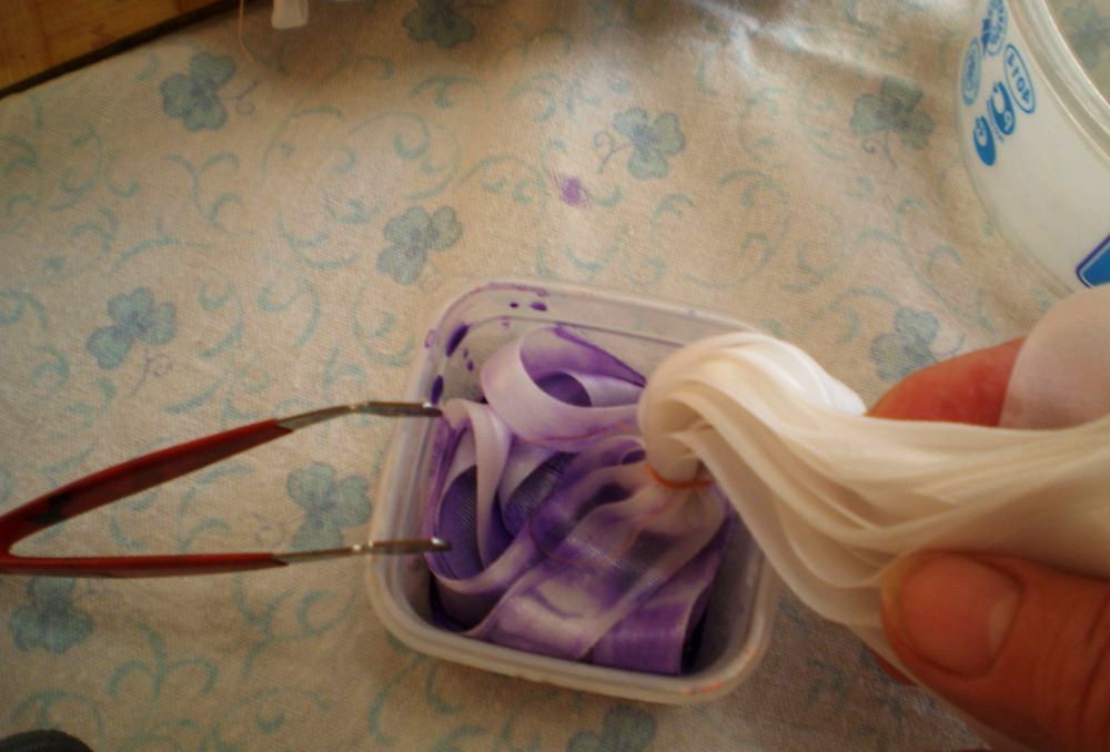 Dipping ribbon ends into paint