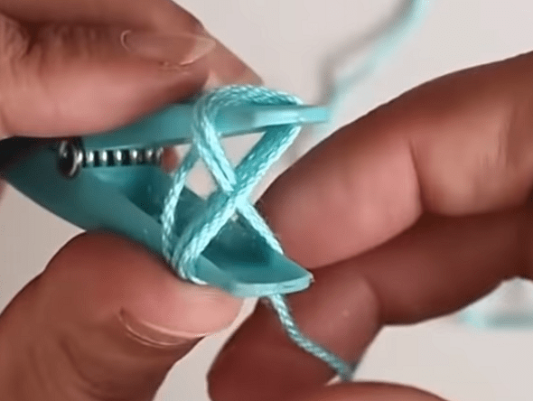 Yarn wound in a figure eight around a clothespin