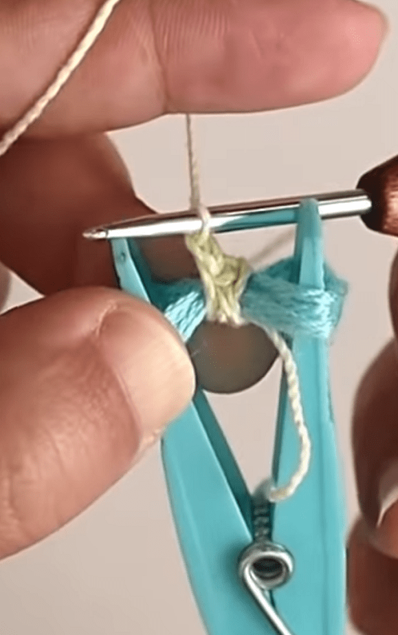 Crocheting around wound yarn on the clothespin