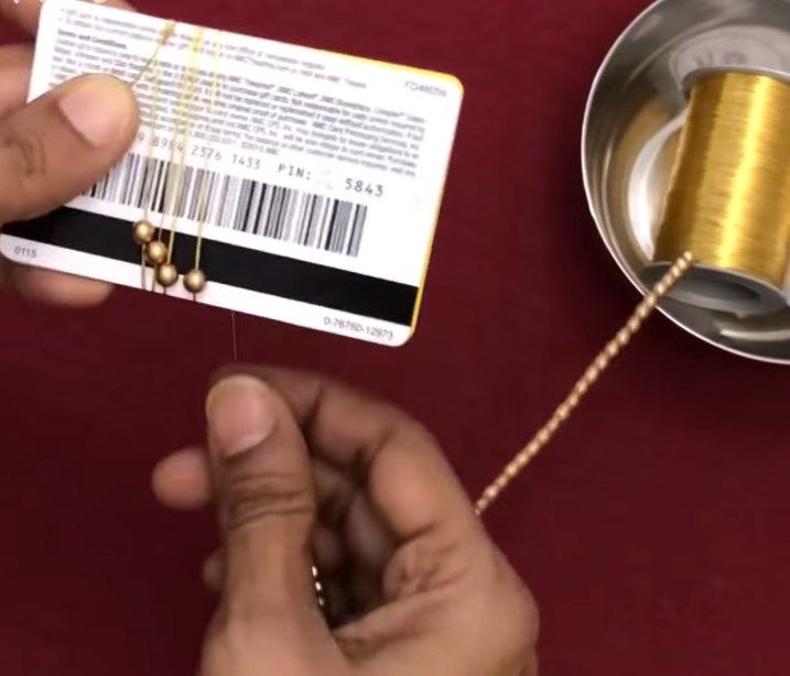Winding the beaded thread around a plastic card