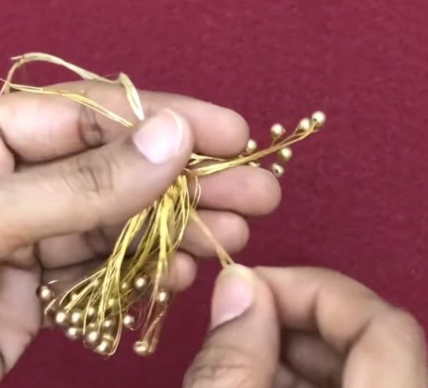 Cinching and securing the top of the tassel with thread